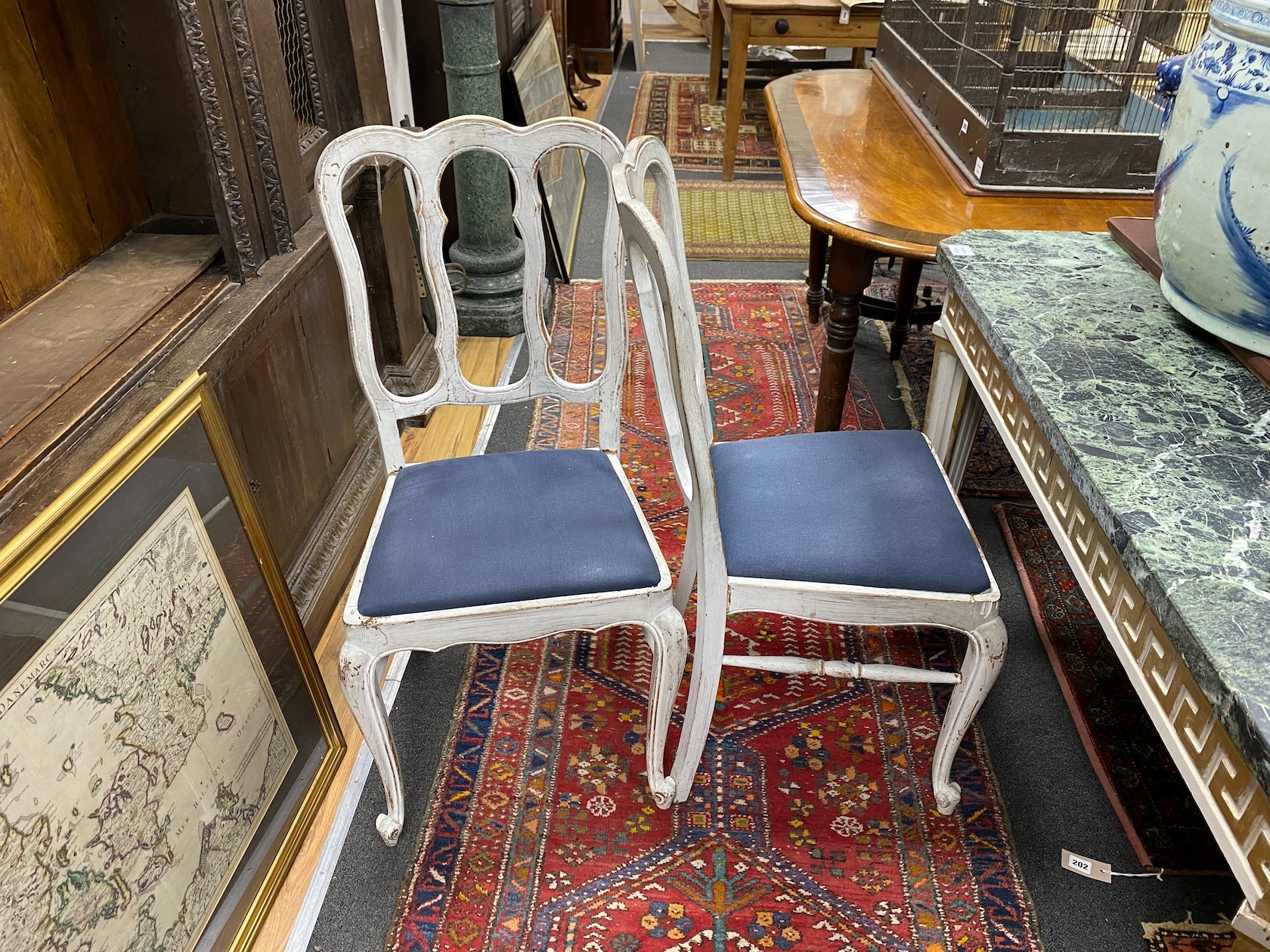 A set of four early 20th century Hepplewhite style painted dining chairs